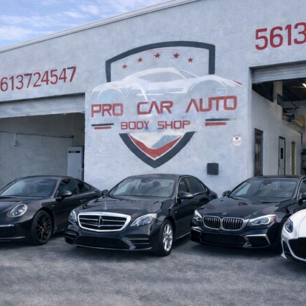 Broward County collision center exterior providing auto body repair and insurance claim services with luxury vehicles outside shop 